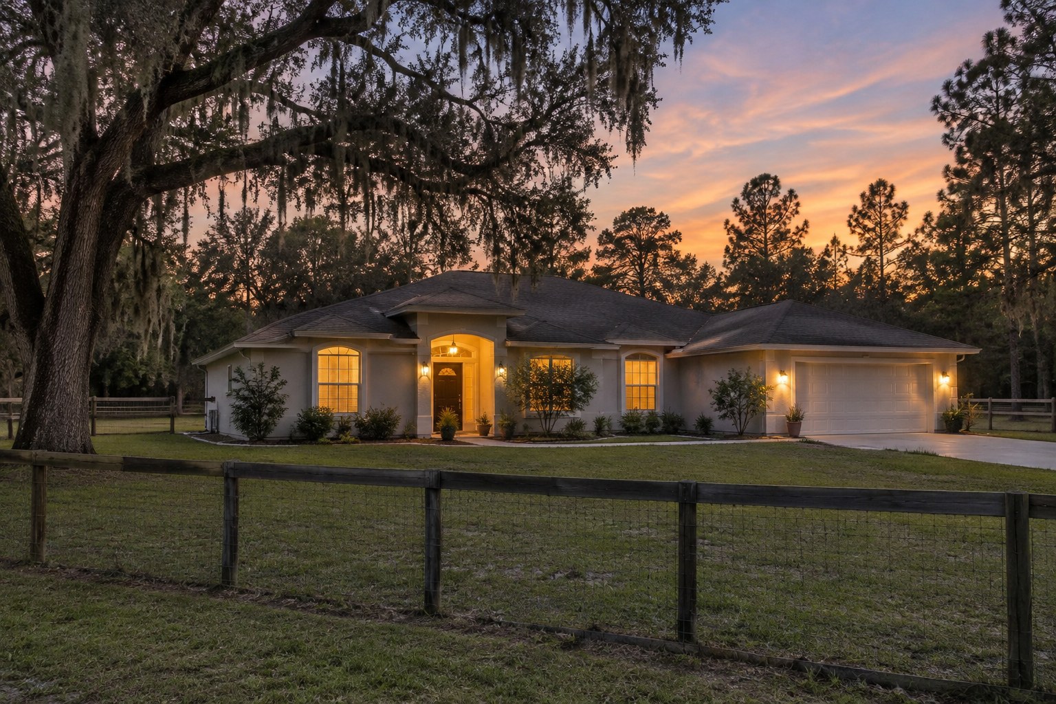 A ranch home on a fenced lot at dusk, illustrative