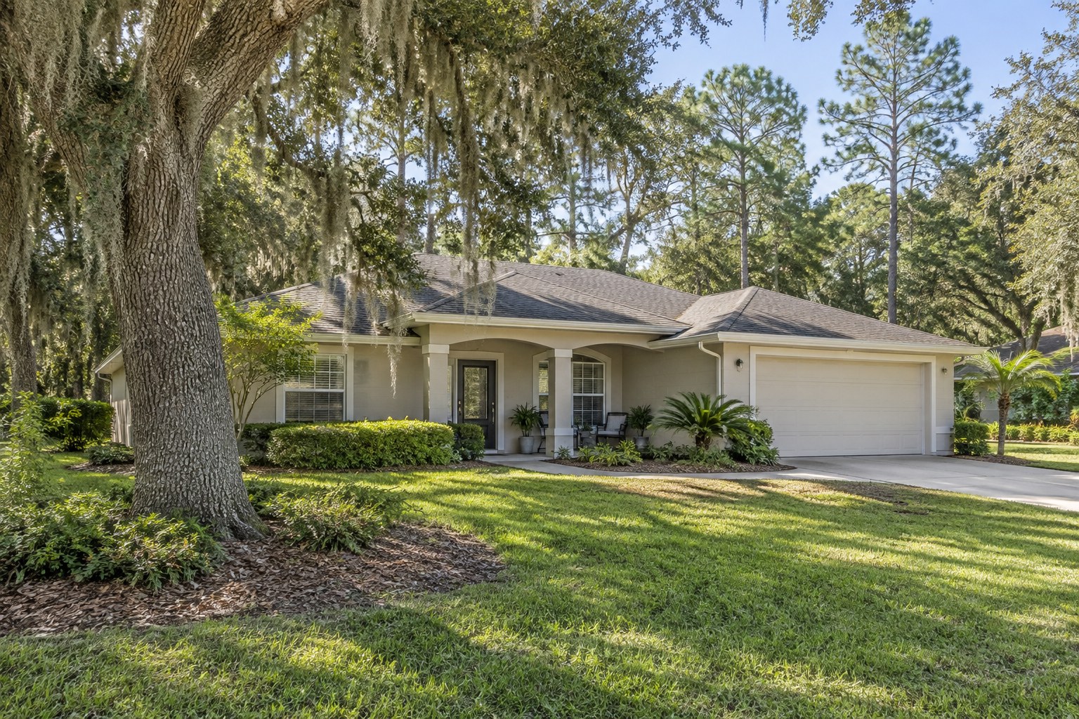 A shaded front porch under a live oak, illustrative